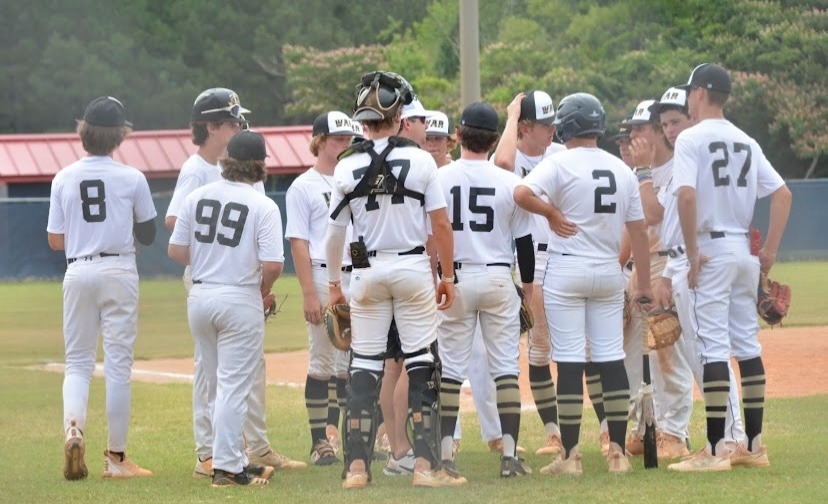 WAR Baseball travel team huddled on the field