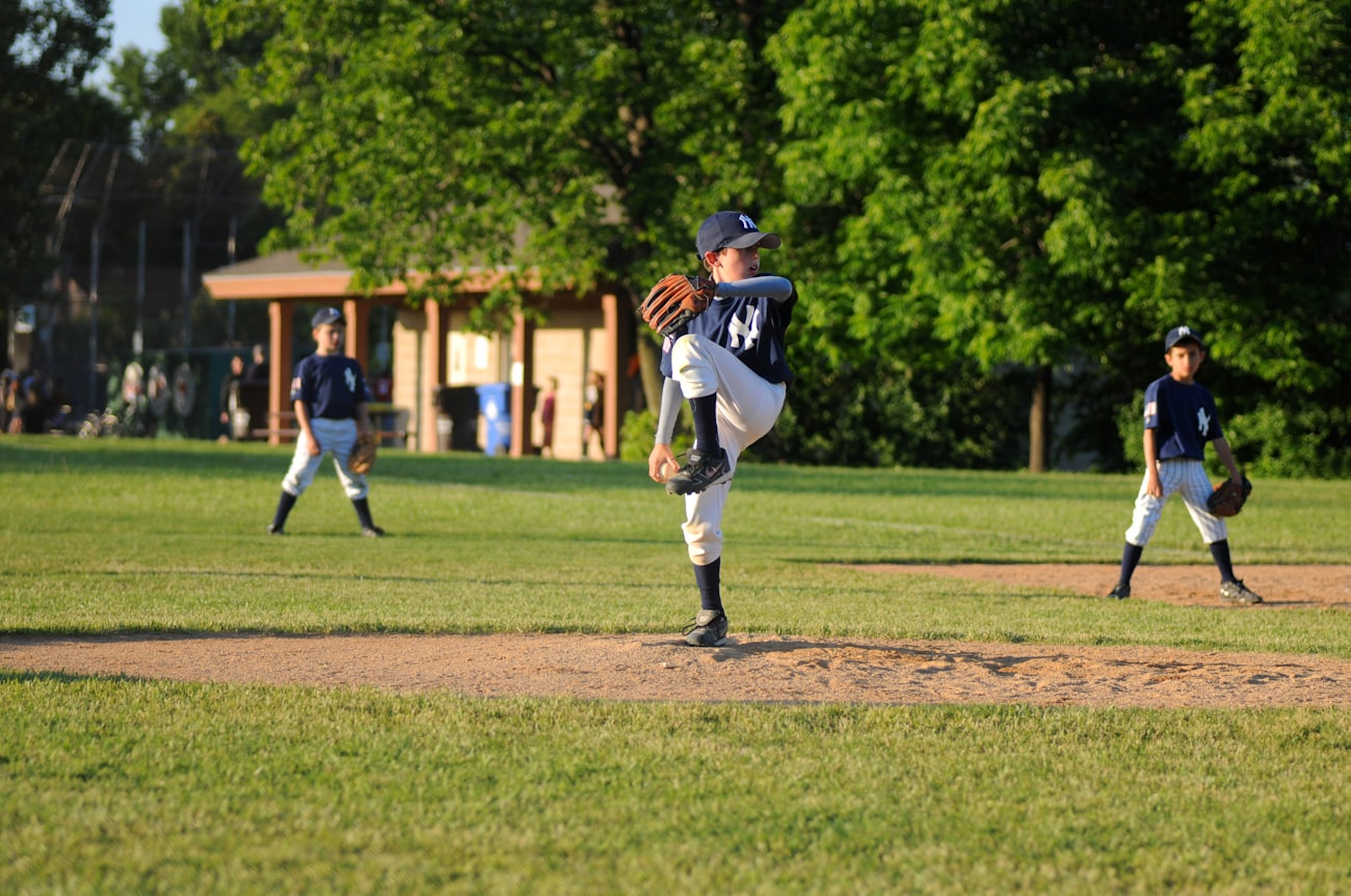 Coach instructing a young pitcher on the mound